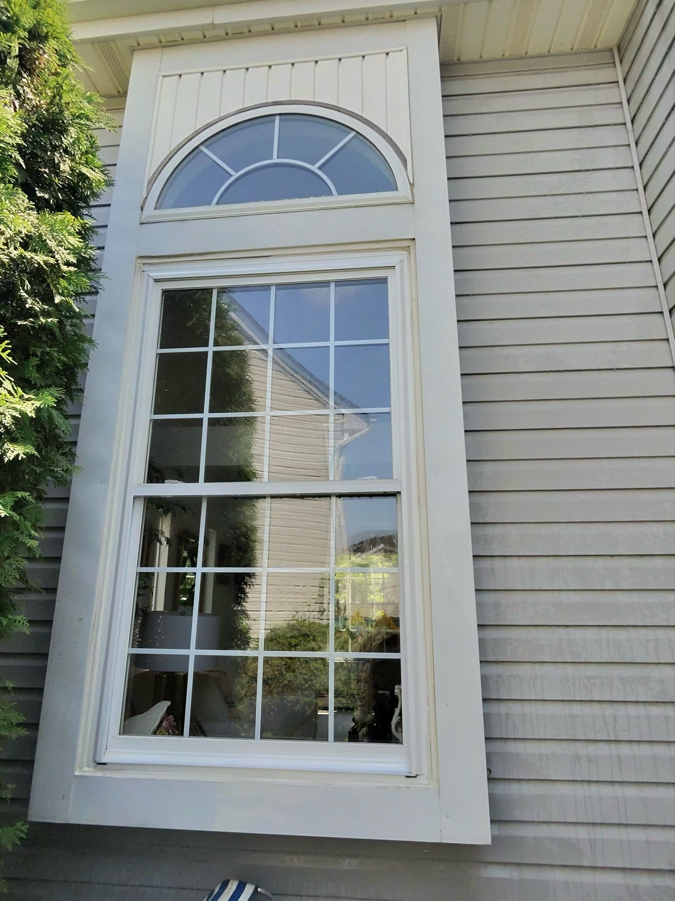Clean residential window with an arched transom