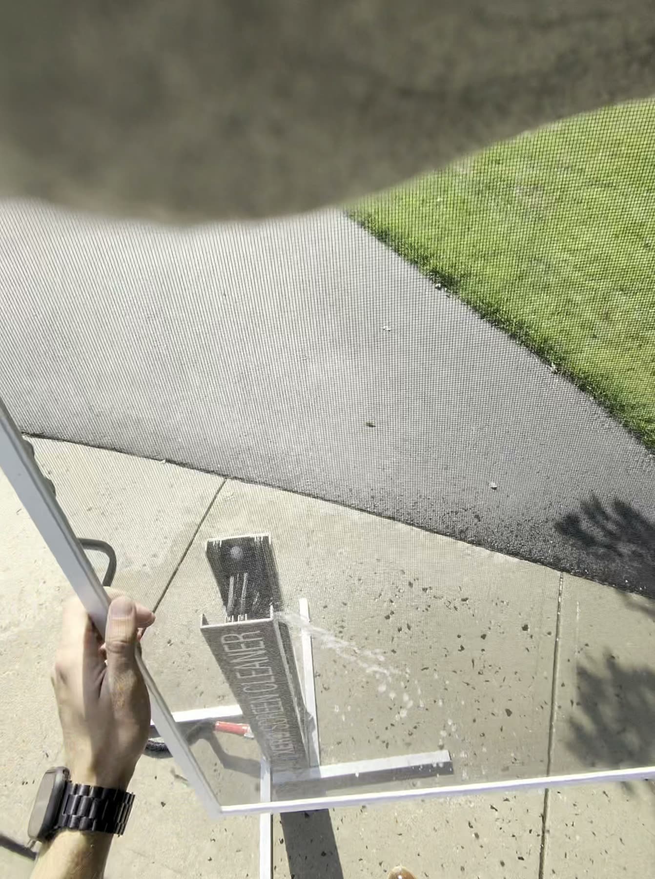 Technician hand cleaning a residential window screen